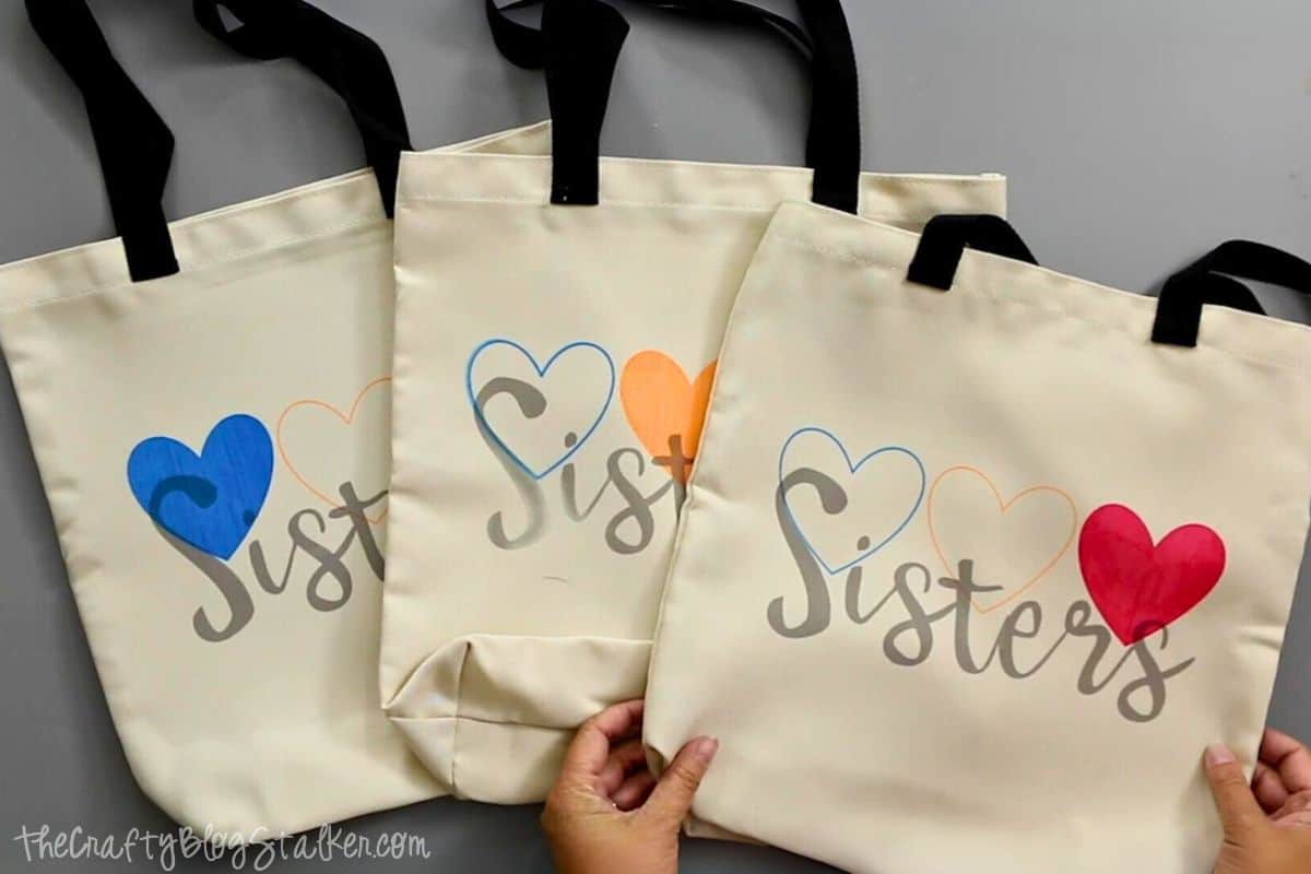Three matching tote bags for sisters made with Infusible Ink.