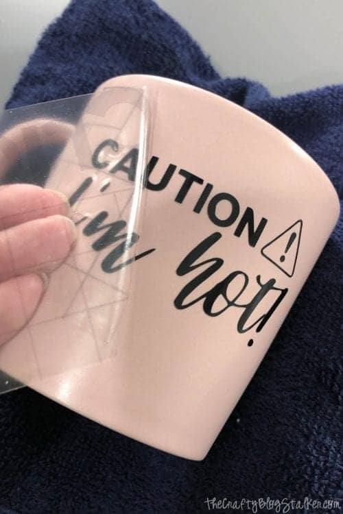 applying the vinyl decal to the coffee mug