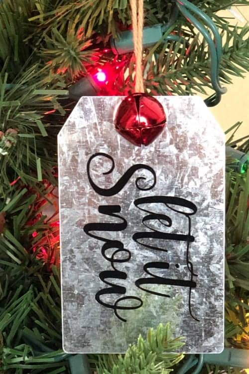 metal tag Christmas ornament hanging on a Christmas Tree