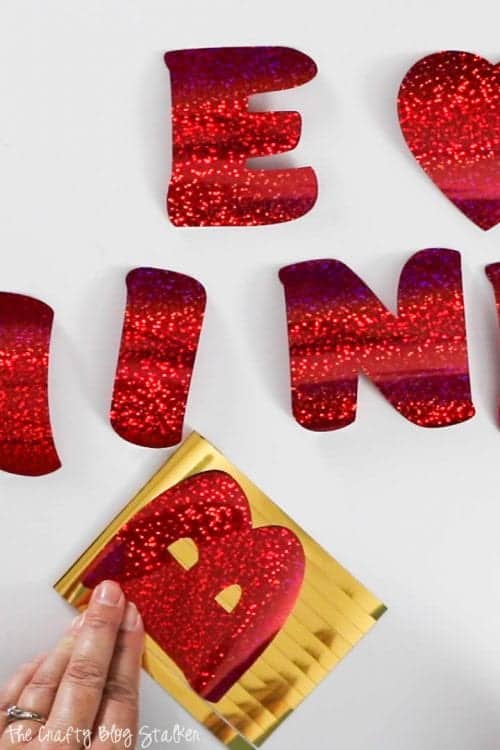 How to Make a Be Mine Valentine's Day Banner with Cricut Party Foil, a tutorial featured by top US craft blog, The Crafty Blog Stalker.