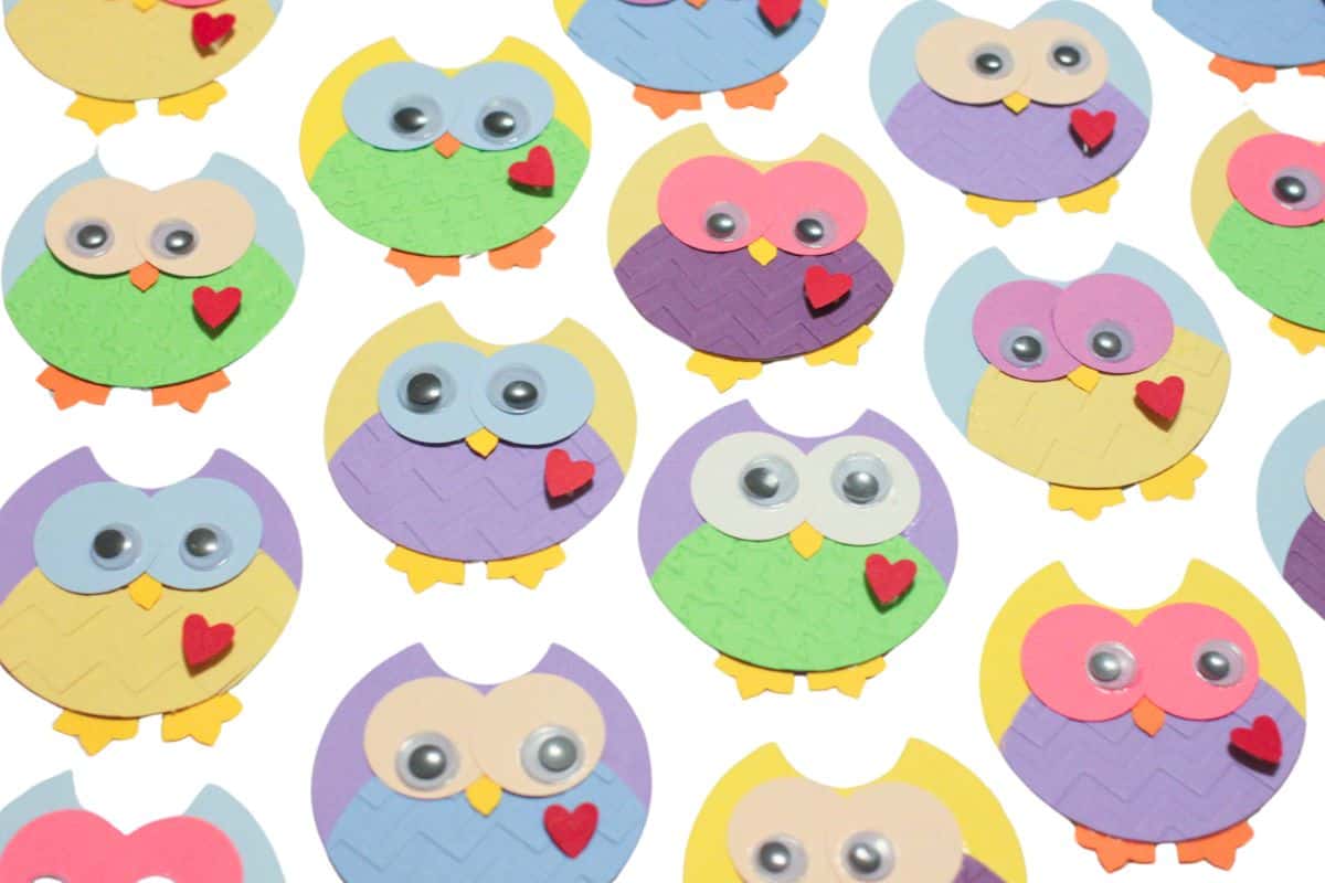 Many paper punch owls, in different colors.