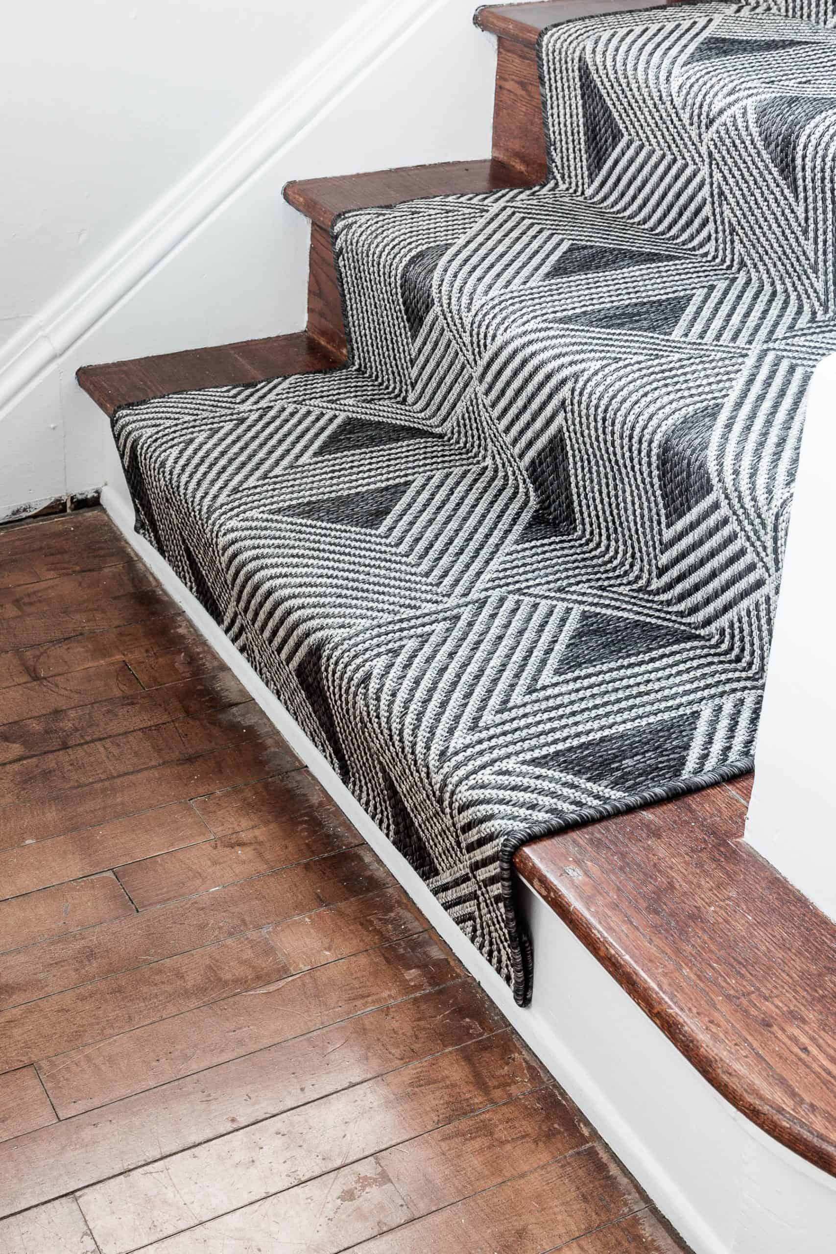 Stair runner with geometric pattern on wooden stairs for home decor.