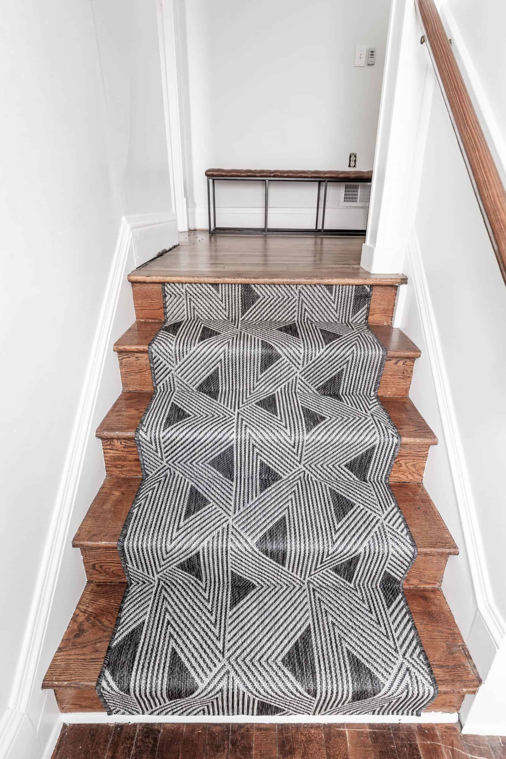 Modern geometric stair runner on wooden stairs for home decor.