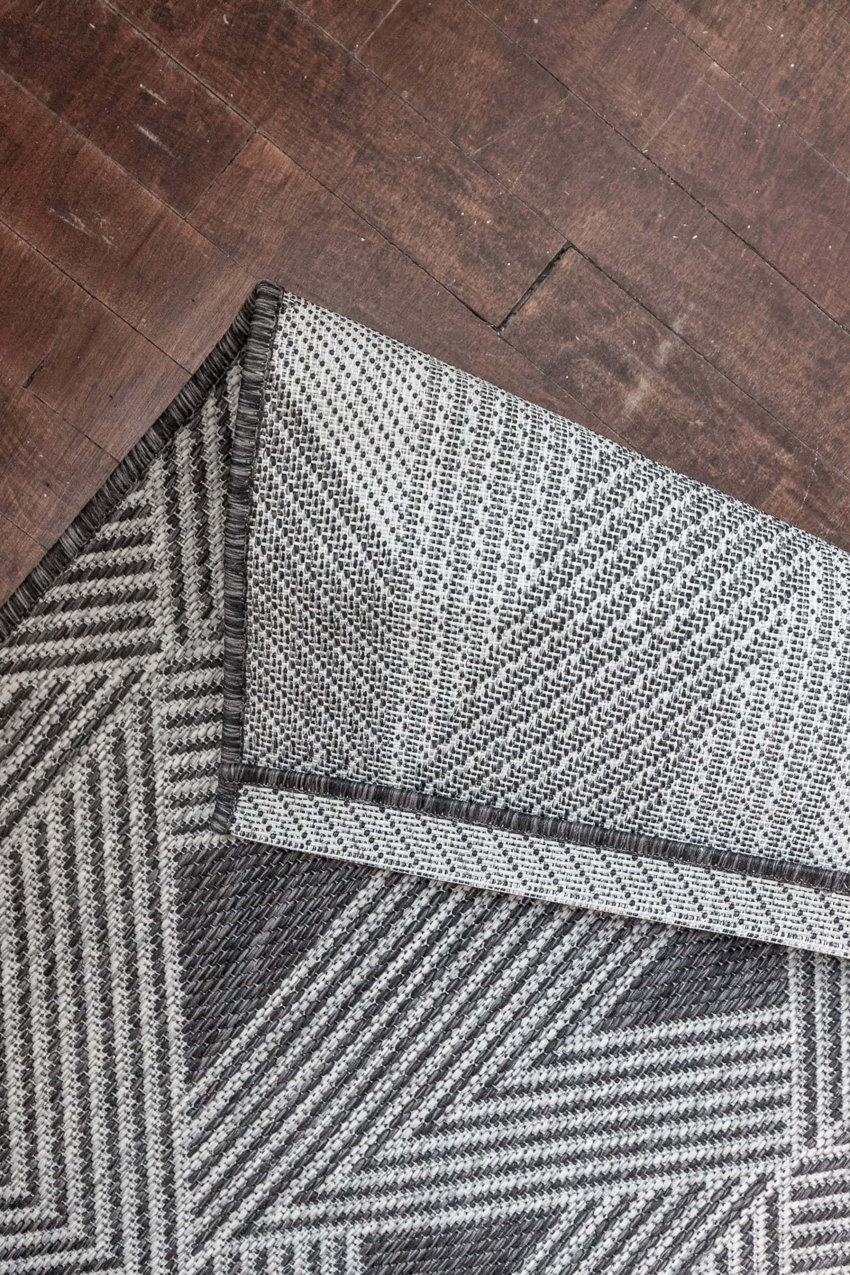 Close-up of a patterned stair runner on wooden stairs for DIY home decor.