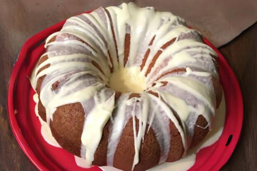 Lemon bundt cake iced and ready to cut into slices.
