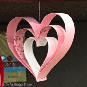 One paper strip heart hanging from a shelf.