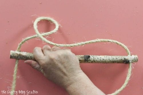stringing the rope through the drilled holes 