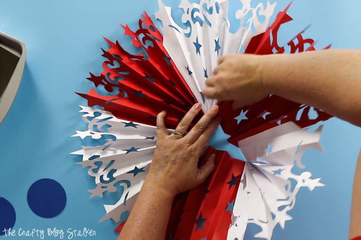 flattening the accordion to create the  Large DIY Patriotic Paper Rosette 