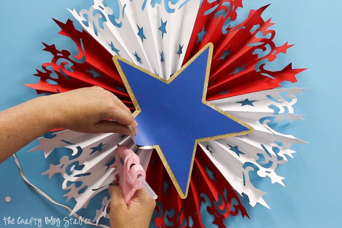 using hot glue to secure the star for the Large DIY Patriotic Paper Rosette 