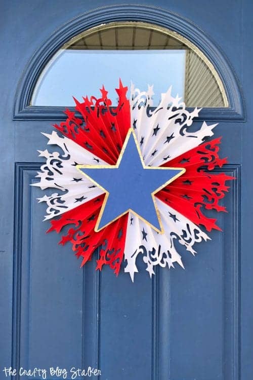 Large DIY Patriotic Paper Rosette hanging on a blue front door