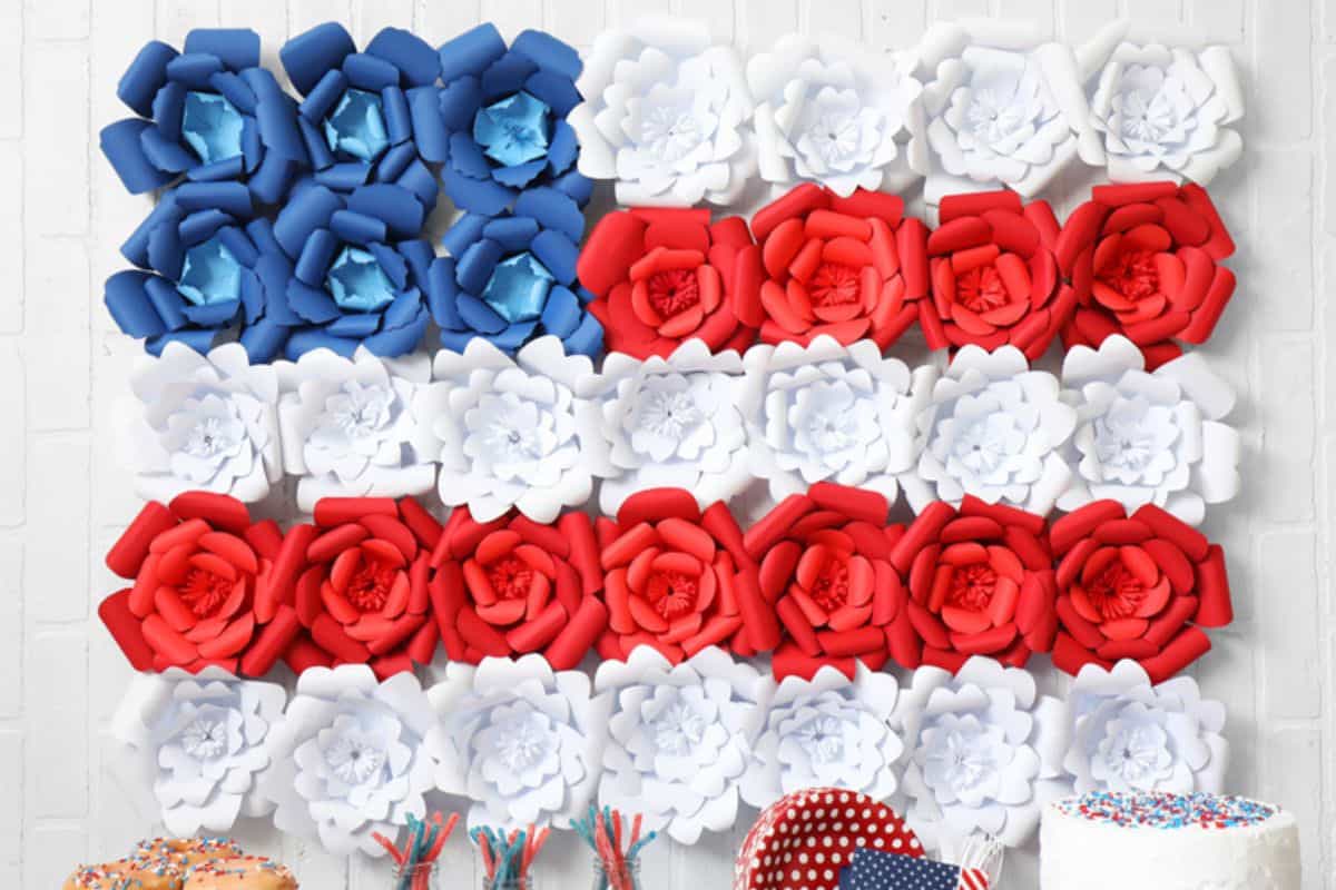 Large American flag made with paper flowers.