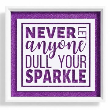 White shadow box frame featuring a purple glitter background and inspirational quote cut from white vinyl that reads, 