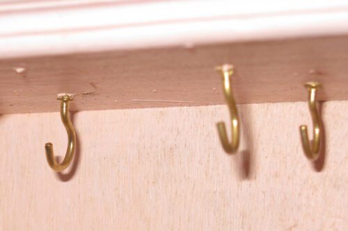 screw hooks at the top of the wardrobe