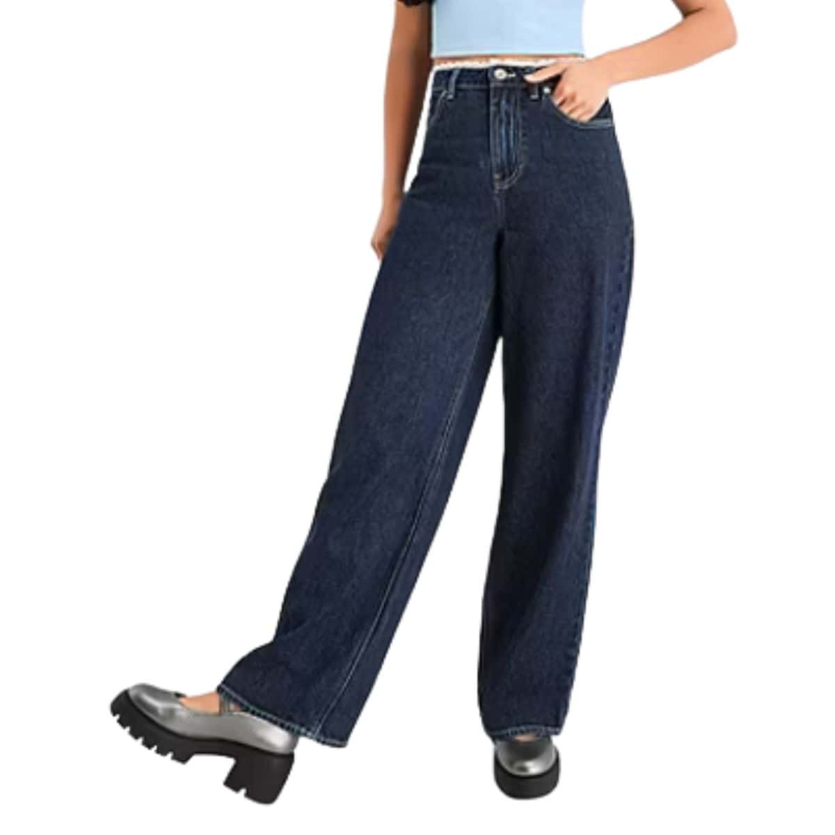 Woman wearing dark blue wide-leg low-rise jeans paired with a light blue crop top and black chunky platform shoes.