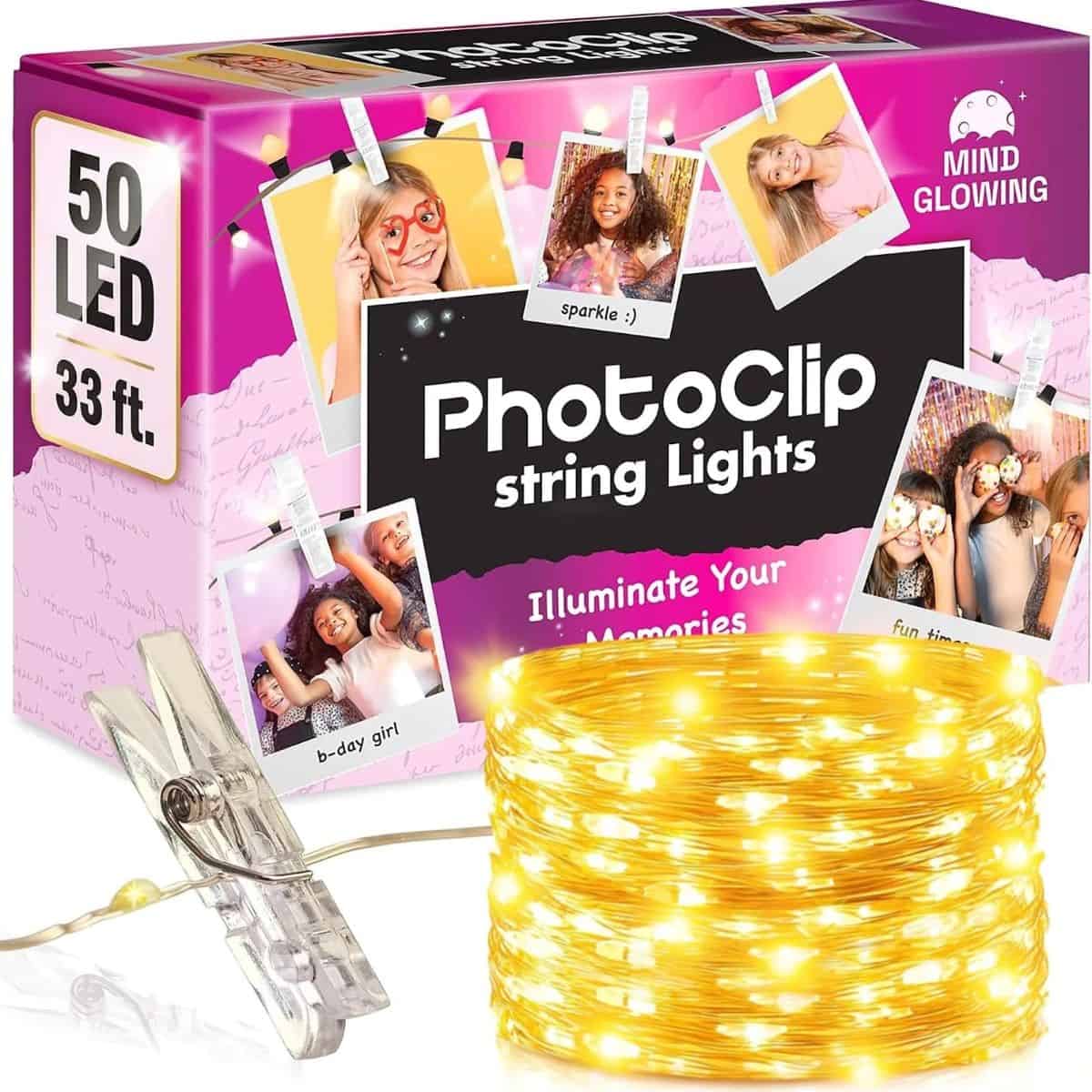 PhotoClip string lights with 50 warm white LEDs, clear photo clips, and a 33-foot light strand displayed beside pink product packaging.