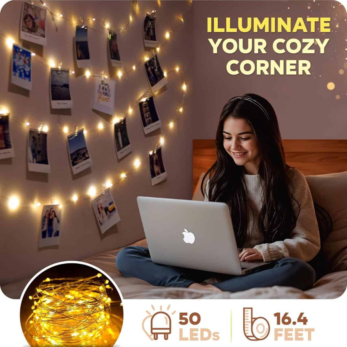 Teen girl using a laptop in a cozy bedroom decorated with warm white LED string lights displaying photos on the wall, creating a soft, inviting glow.
