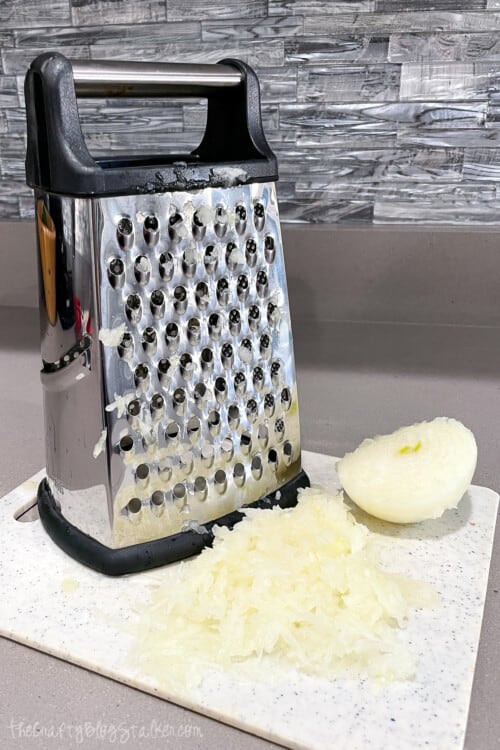 a cheese grater and onions