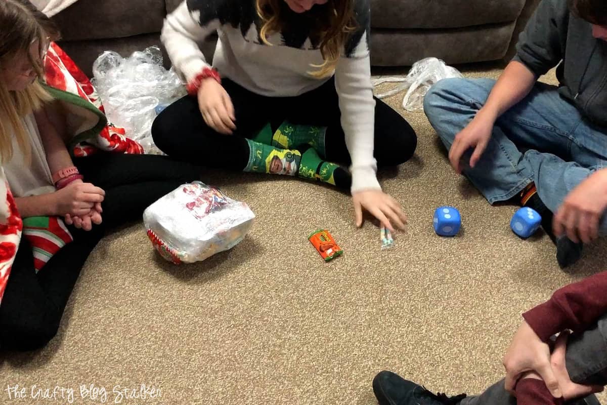 Teenagers on the floor playing a Christmas party game.