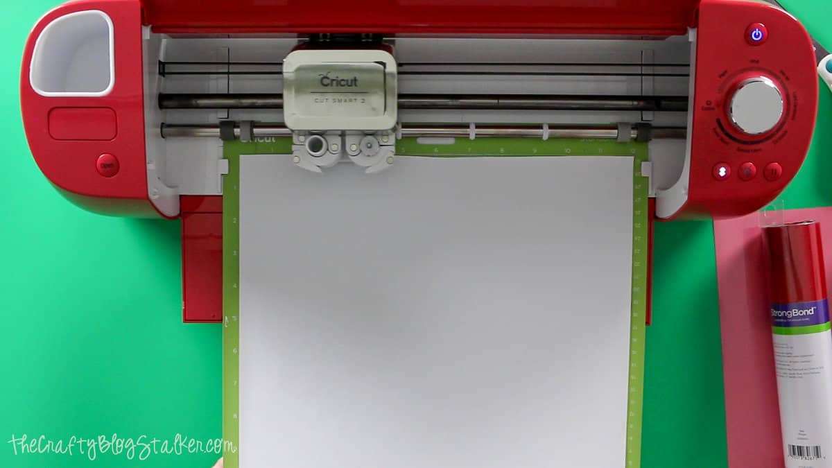 the cricut cutting the design out of heat transfer vinyl