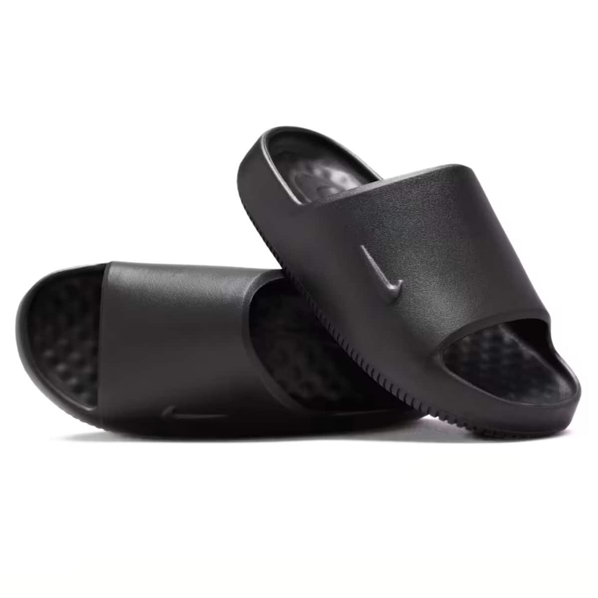 Pair of black suede slippers with white faux fur lining and durable rubber soles, designed for comfort and indoor or outdoor wear.