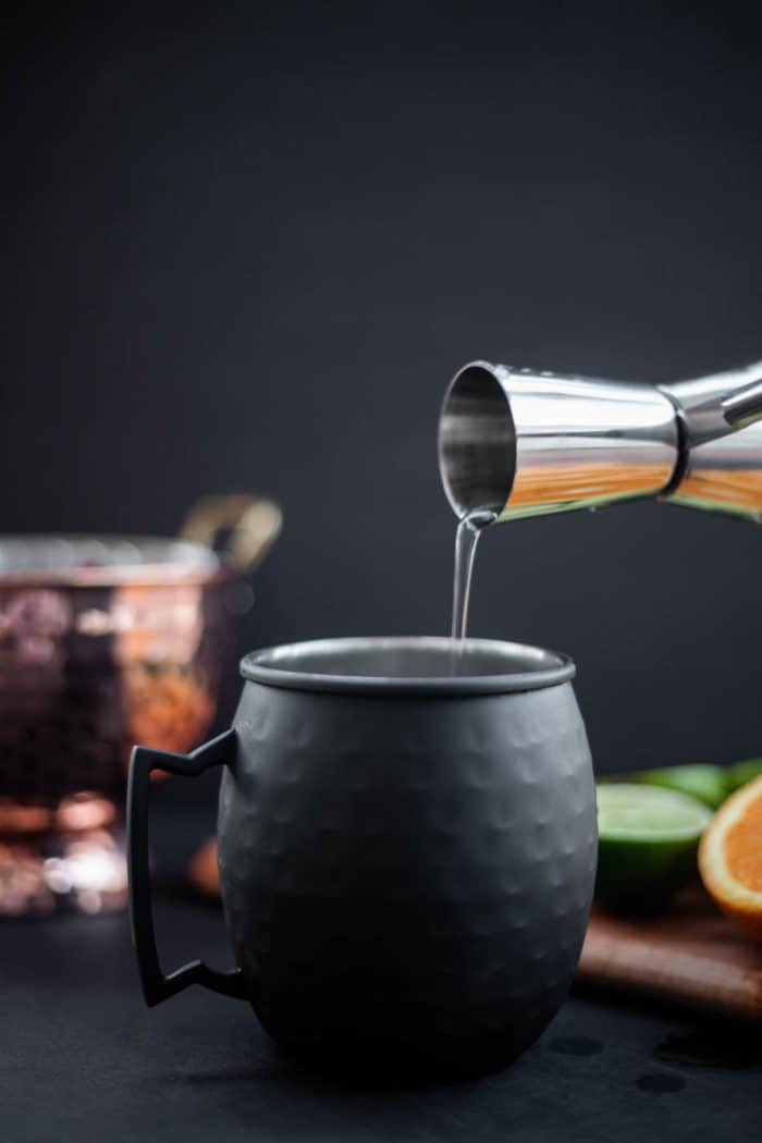 Pour vodka in an Orange Moscow Mule