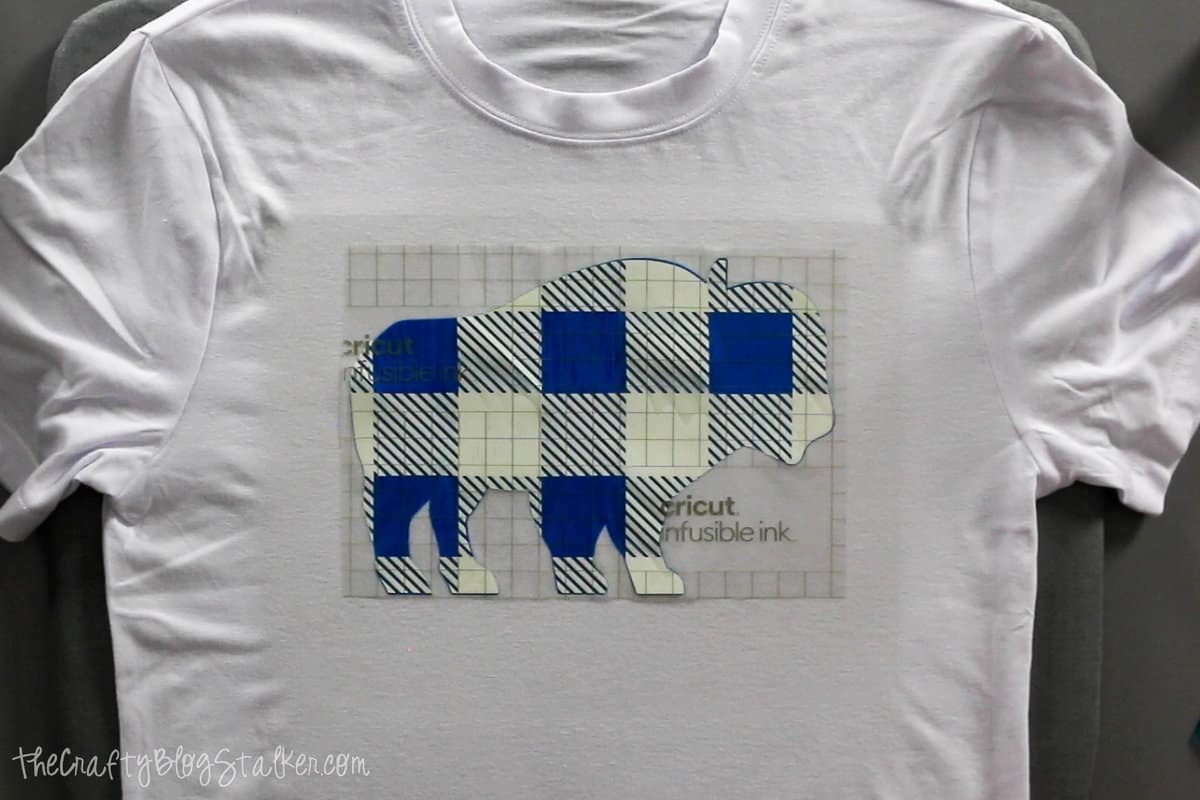 adding the plaid layer of infusible ink to the buffalo pajama shirt