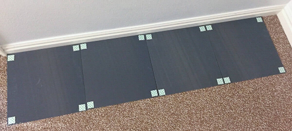 Black mirror tiles with decorative corner accents for wall decor.