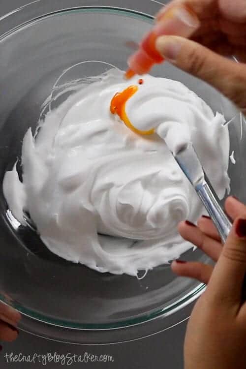 stirring in soap dye into the slime mixture