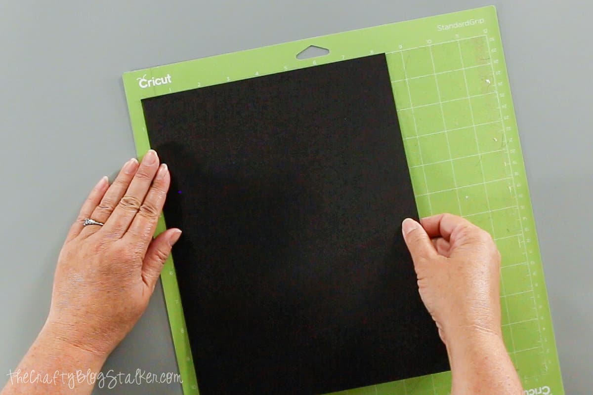 placing black cardstock on a standard grip mat