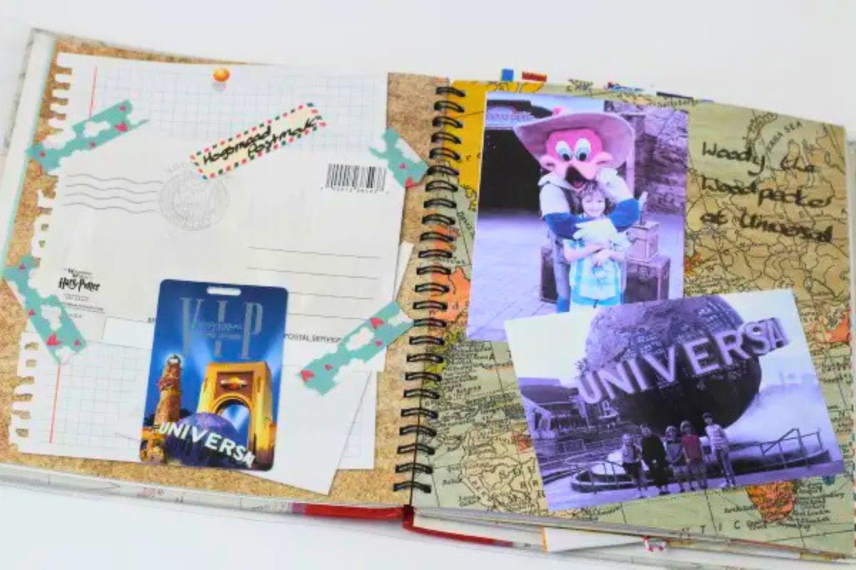 A colorful smash book spread with Universal Studios memorabilia, including photos, a VIP pass, a postcard, and themed washi tape on a map-patterned background.