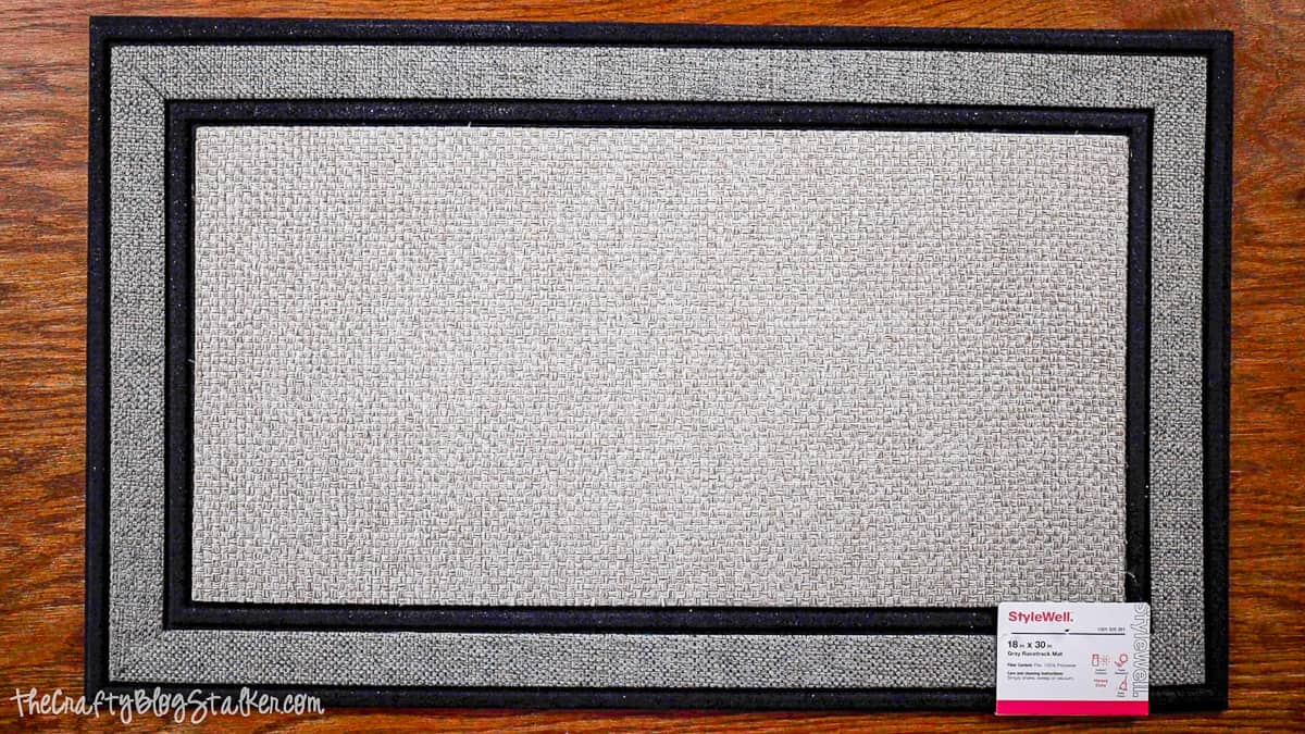 18 x 30 inch gray front door mat that is 100% polyester.