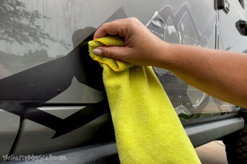 pressing out the bubbles with a microfiber cloth