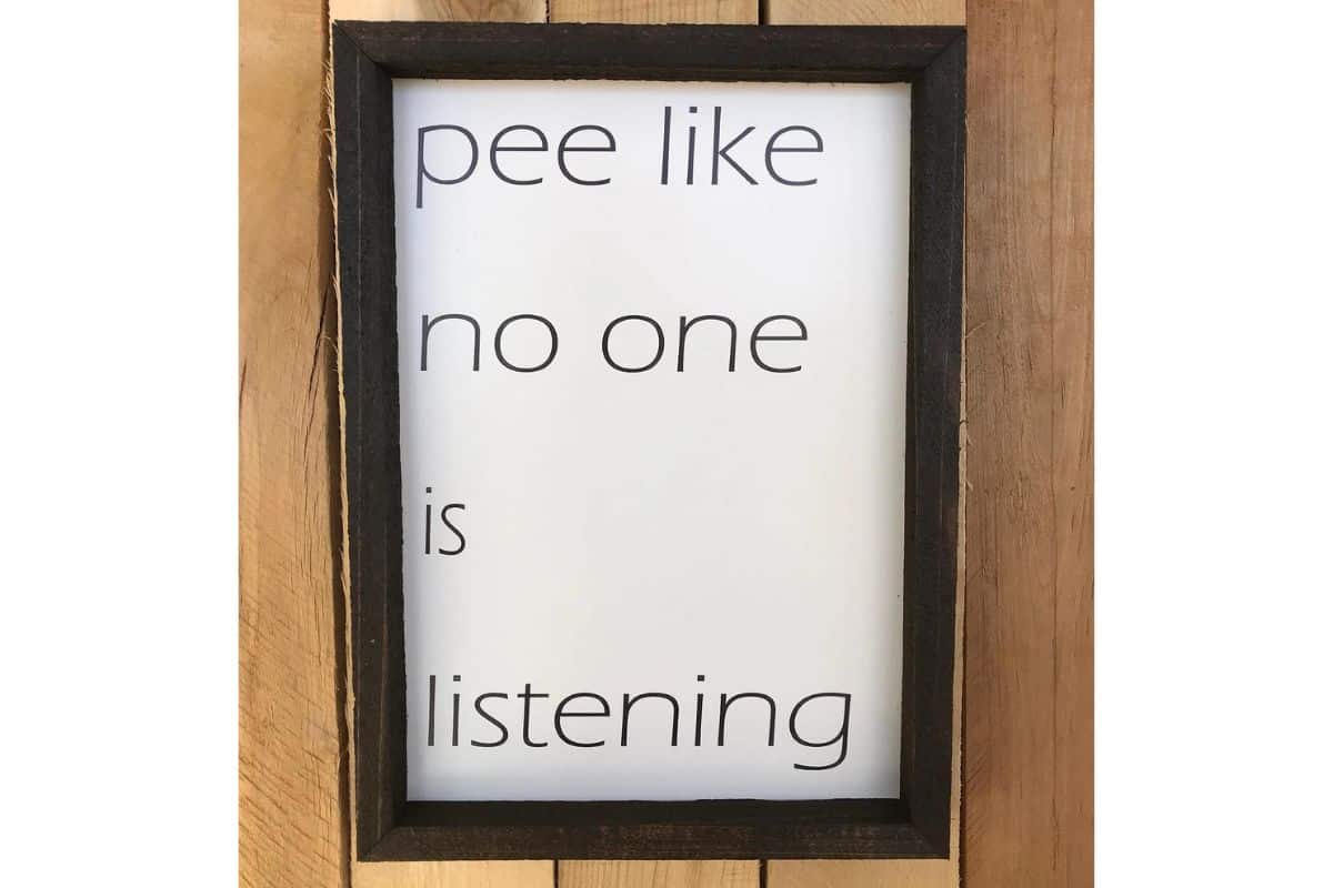A sign that reads - pee like no one is listening.
