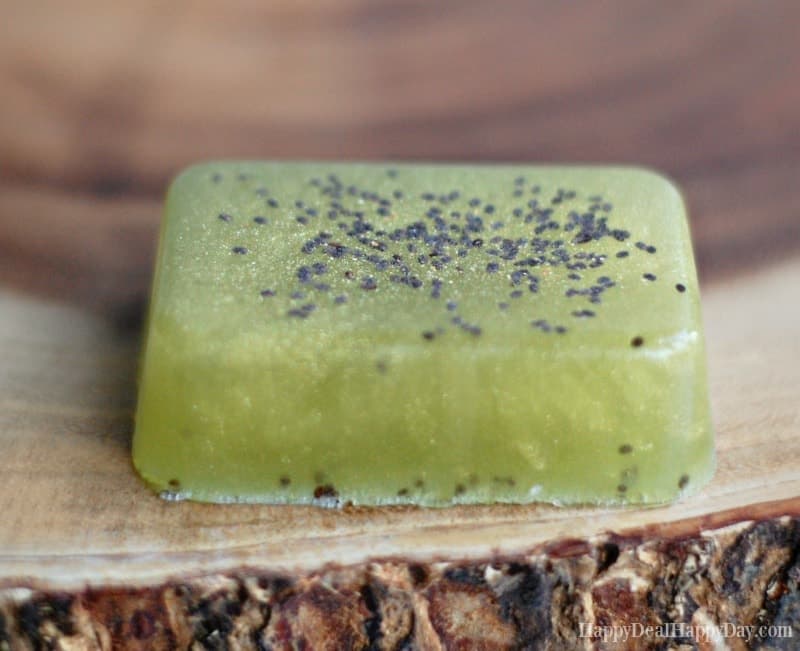 Close up of a green bar of soap with chia seeds.