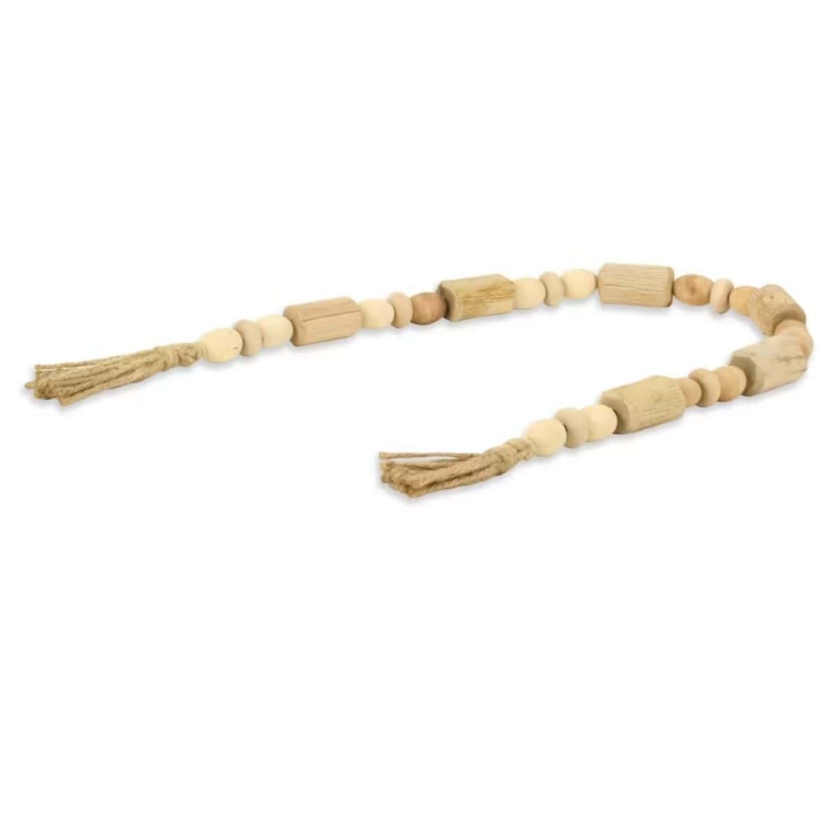 Natural wood bead garland with mixed round and rectangular beads and jute tassels at both ends on a white background.