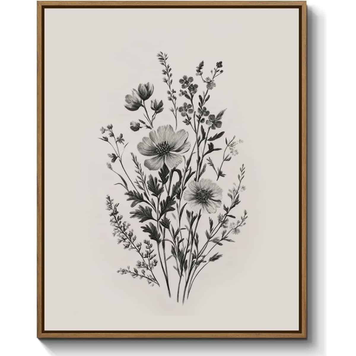 Framed black-and-white botanical drawing of wildflowers and leafy stems on a neutral background in a simple wood frame.