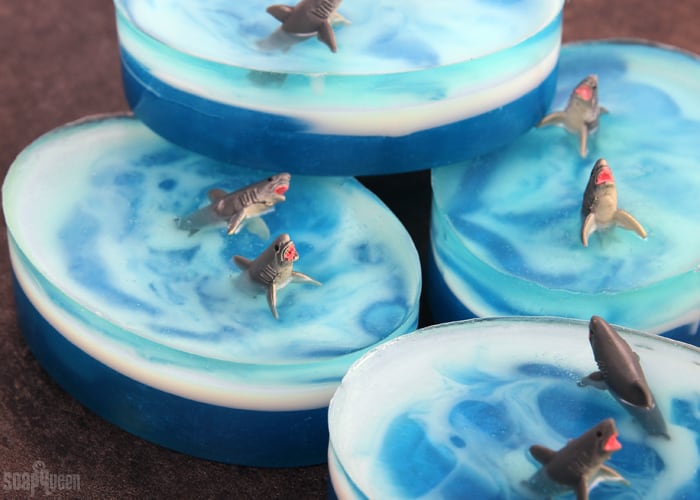 Layered blue soap that looks like the ocean with little toy sharks.