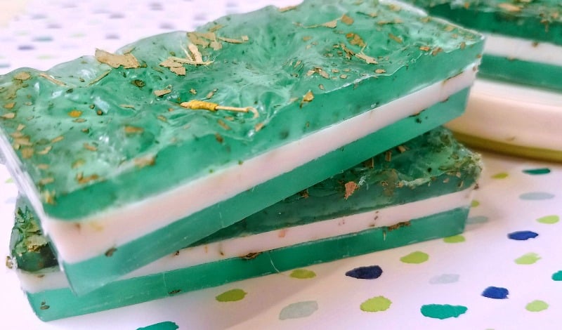 Green and white layered soap with dried herbs.
