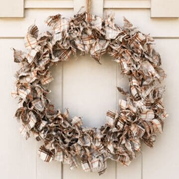 Fall fabric wreath hanging on a front door.