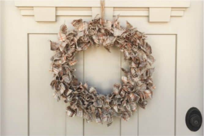 Fall fabric wreath hanging on a front door.