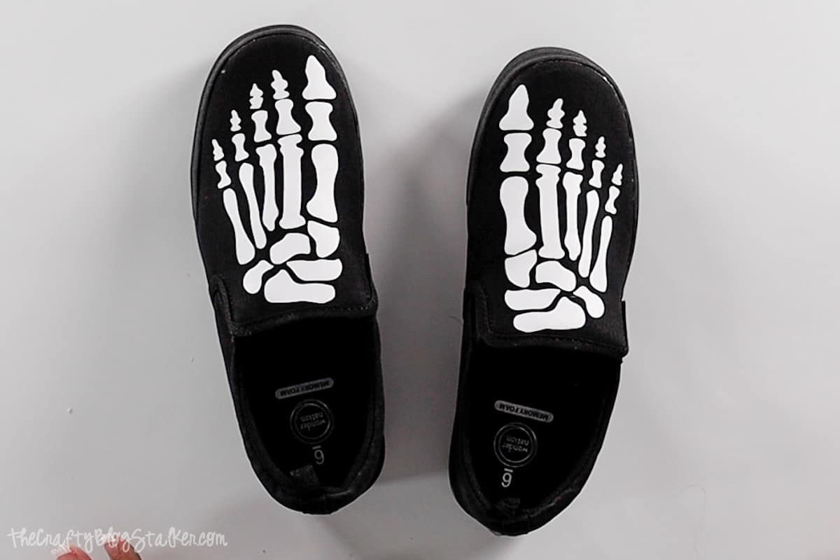 Black shoes with white skeleton feet.