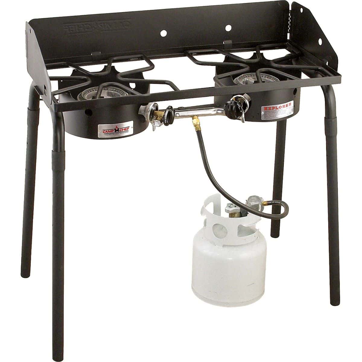 Camp Chef outdoor propane stove with two red control knobs, folding legs, and a connected propane tank, shown on a white background.