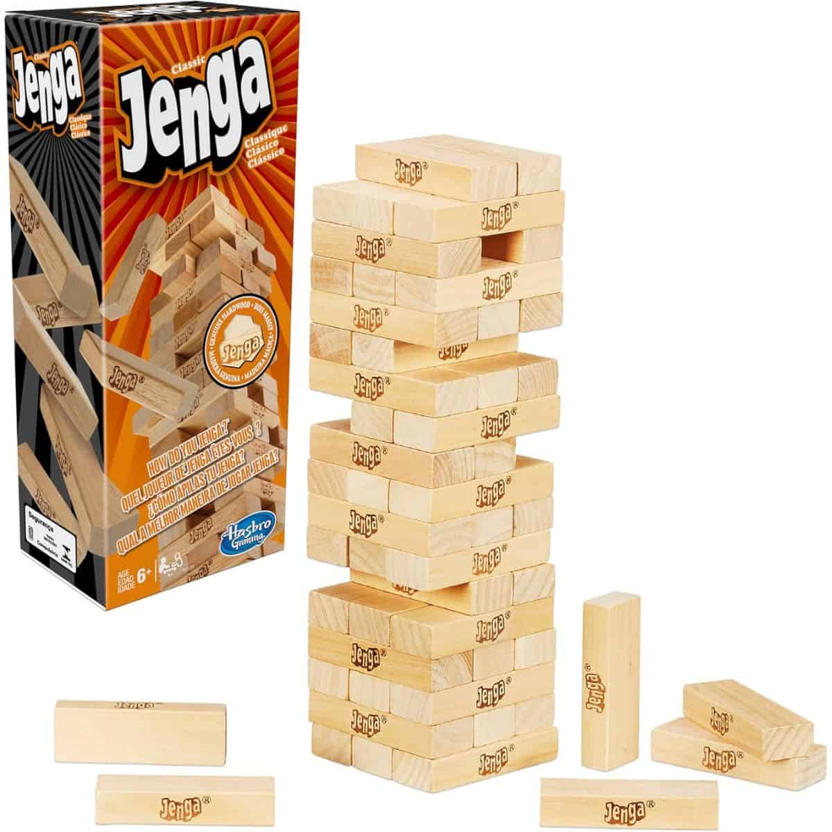 Classic Jenga game with stacked wooden blocks and pieces scattered beside the box, displayed against a white background.