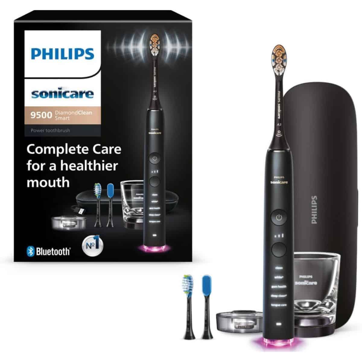 Philips Sonicare DiamondClean 9500 electric toothbrush with travel case, charging glass, brush heads, and product packaging.
