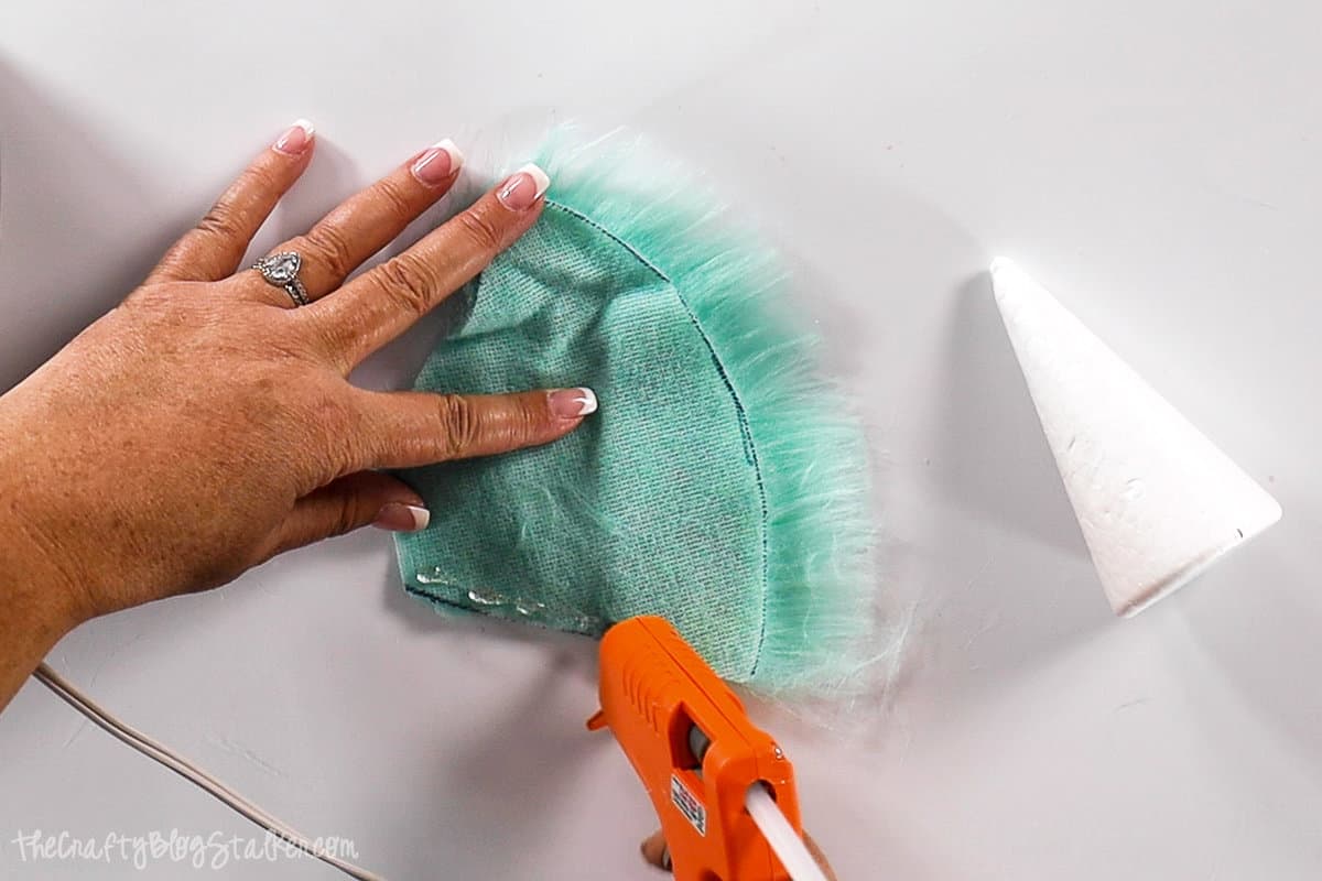 applying glue to the edge of faux fur fabric