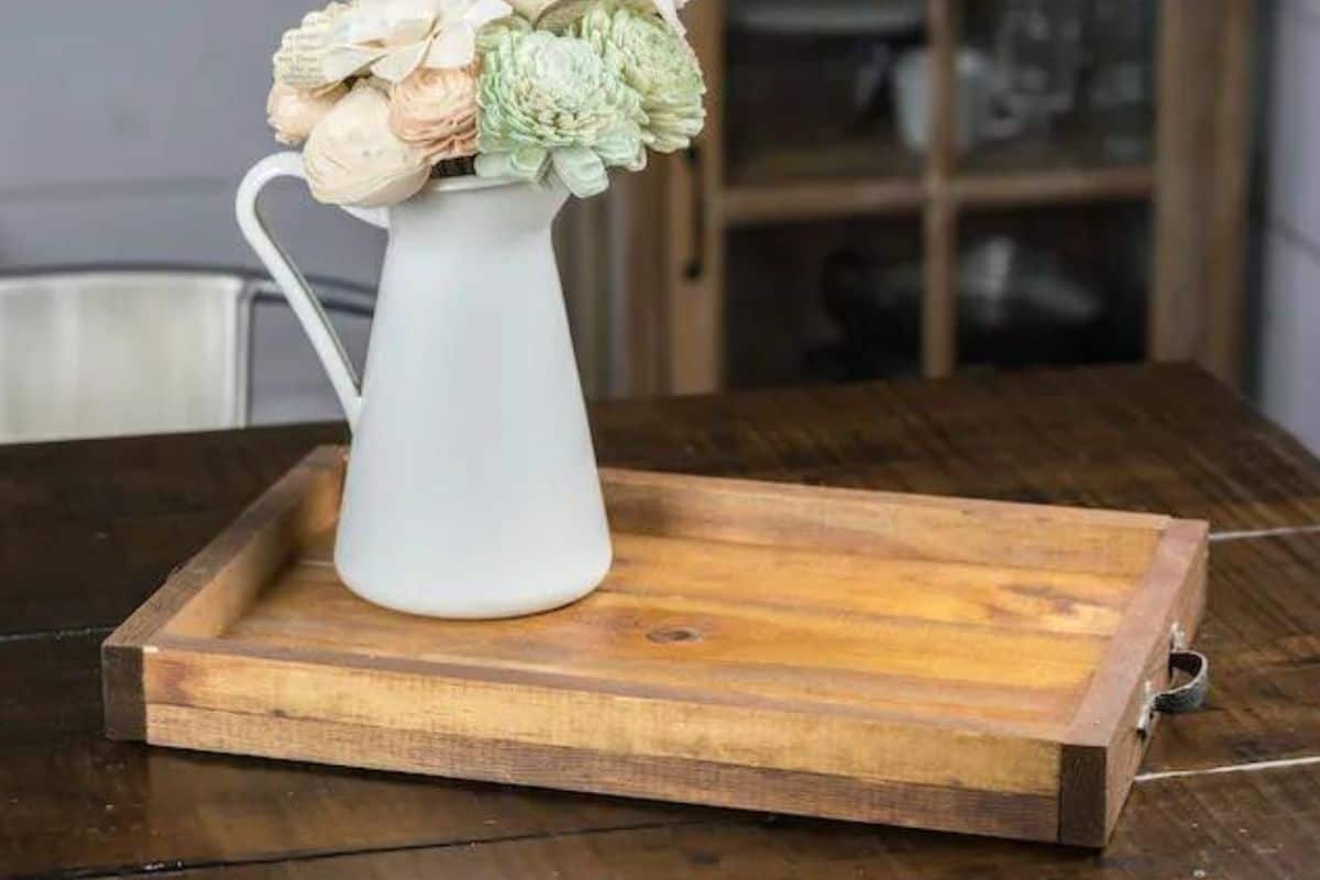 DIY Wooden Tray holding a vase of flowers