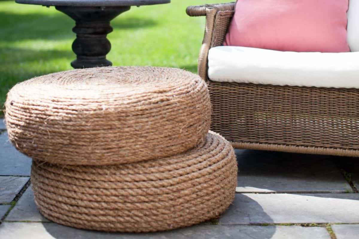 Two stacked rope ottomans outside on a porch.