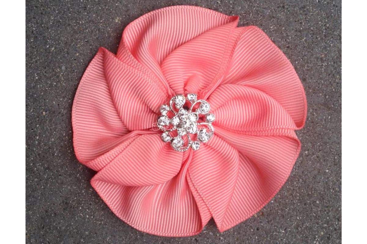 Pink amelia ribbon flower with a center rhinestone. 