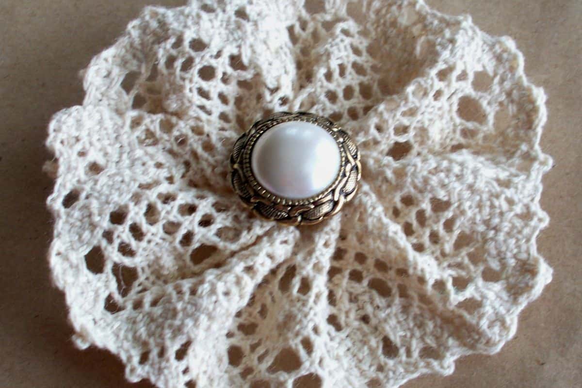 Lace flower with a pearl in the center.