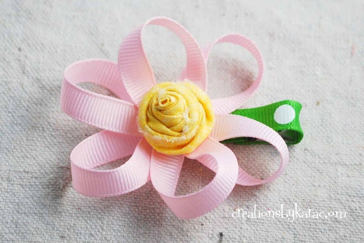 Pink loopy flower on a hair clip.